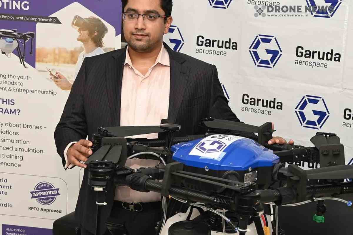 A man standing with a agriculture drone