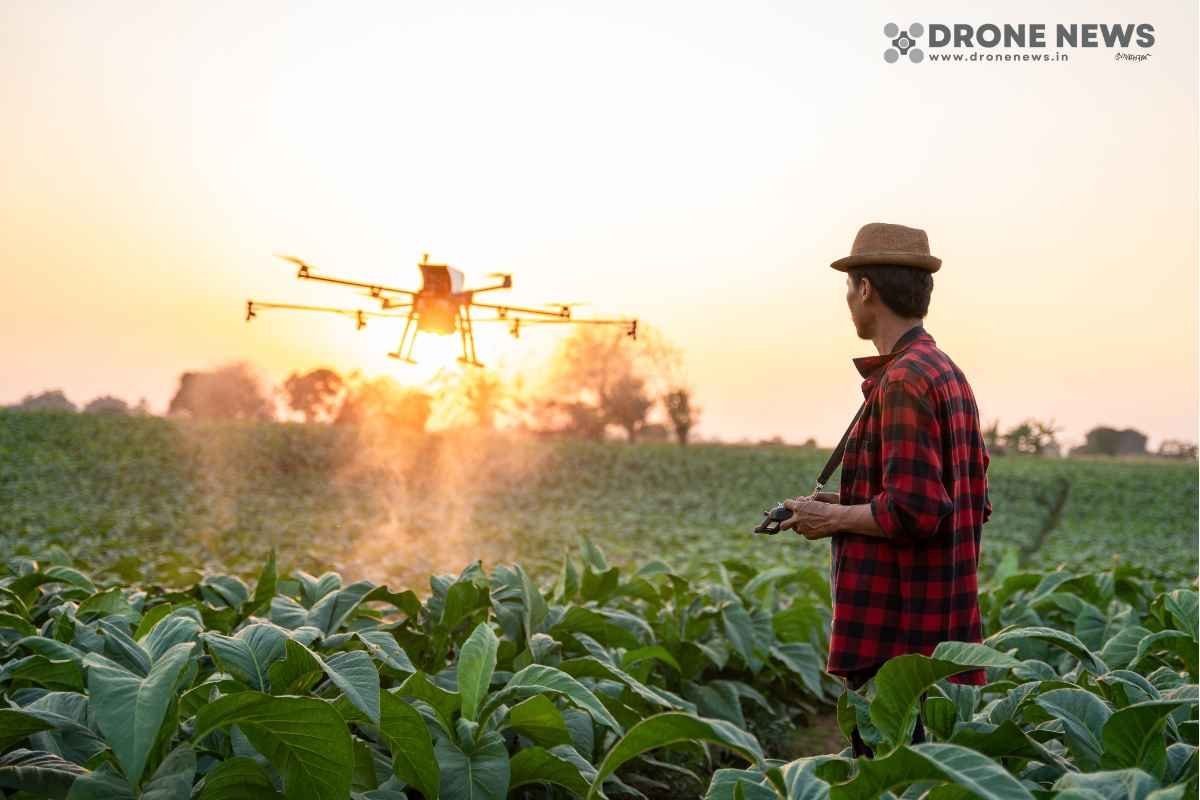 Farmer in field flying a agricultural drone a man in a hat standing in a field with a drone flying over